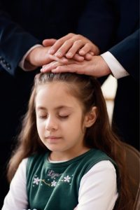 Little girl being blessed